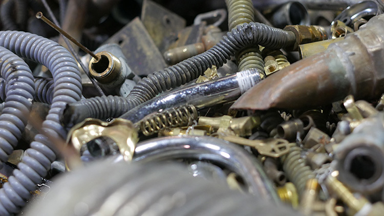 Mixed household metal: copper tube, brass fittings, and steel parts